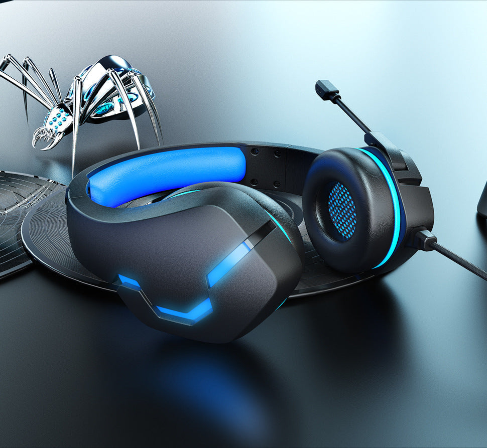 Black-blue wired gaming headset in a blue desk setup