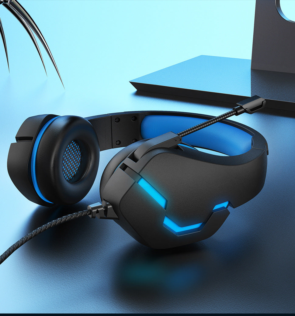 Black-blue wired gaming headset in a clean desk setup